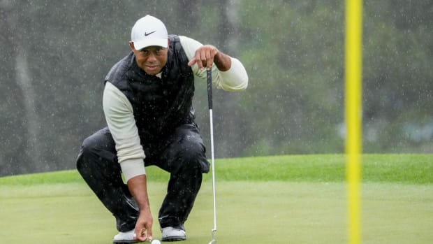 Tiger Woods lines up his putt on the 18th green during the second round of The Masters in April.